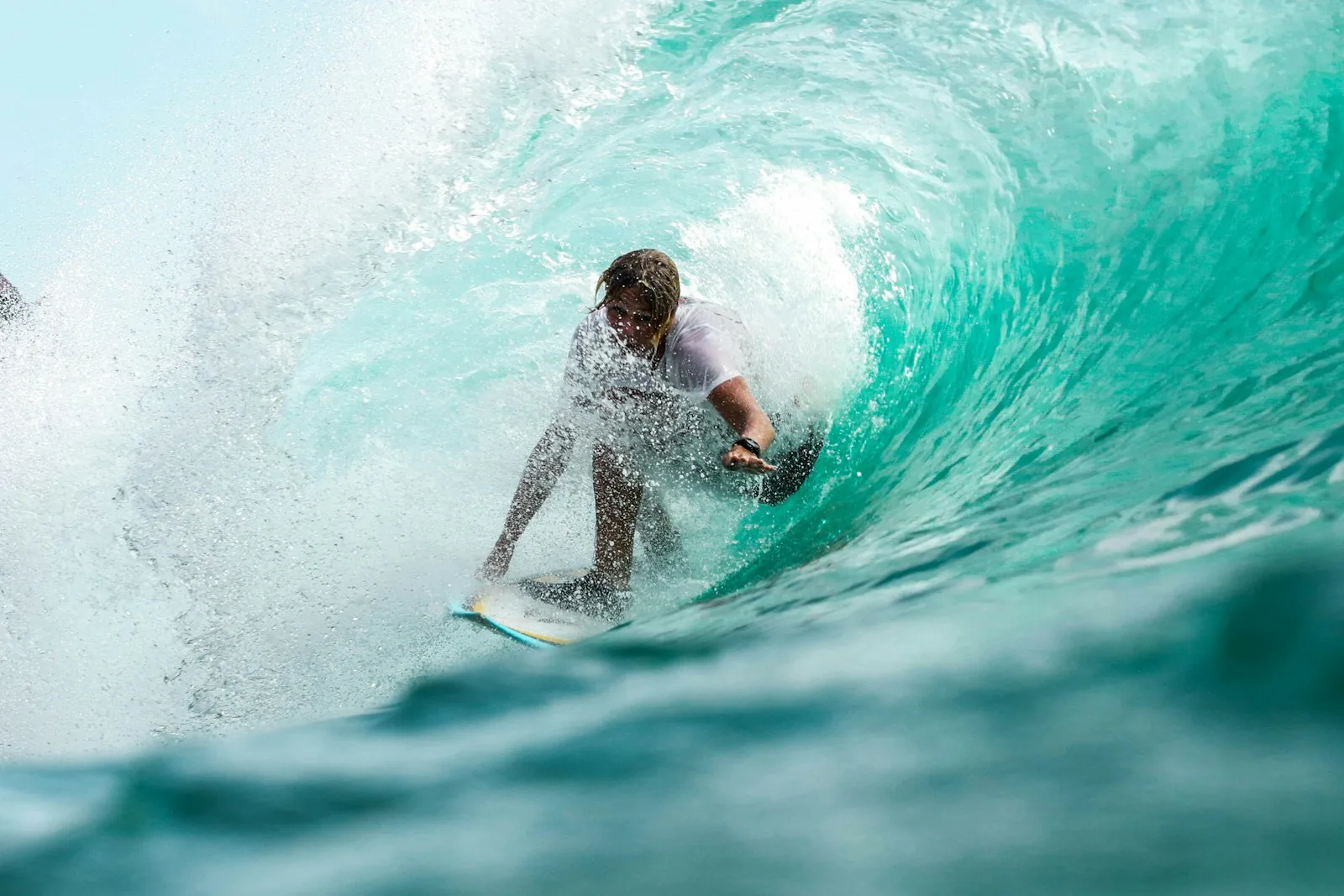 Surfer riding a wave at sunrise